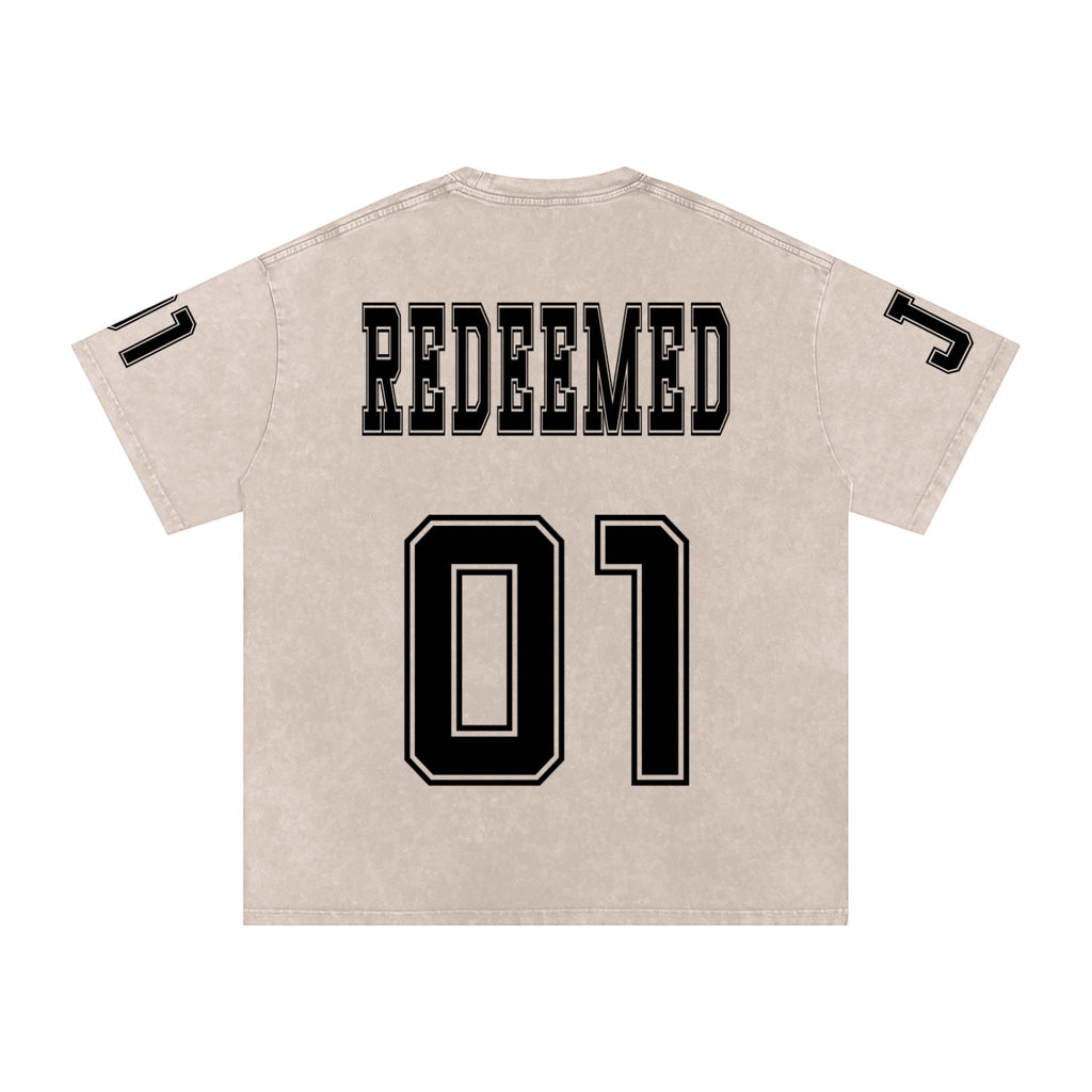 Foundation oversized washed cotton t-shirt with "REDEEMED" and "01" graphic print. Features collegiate-style lettering and vintage feel.