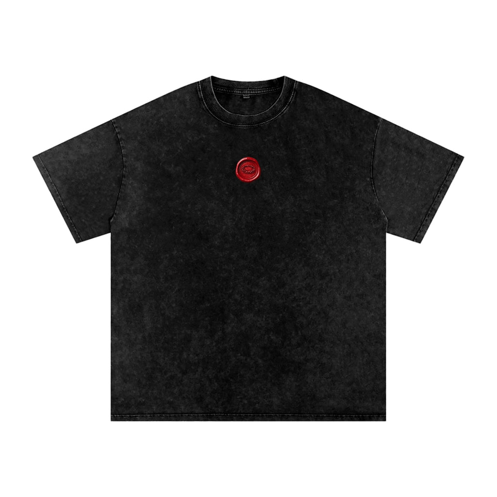 Foundation oversized vintage-washed black cotton t-shirt with red wax seal graphic on chest.